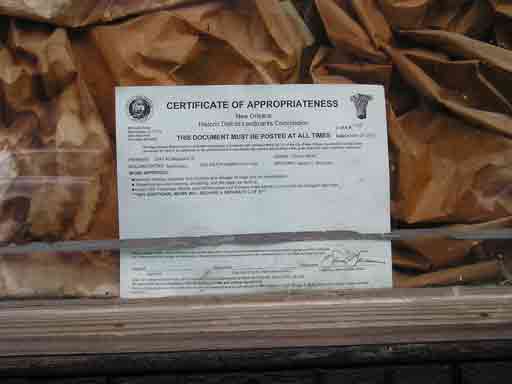 photograph of certificate of appropriateness in New Orleans shop window, summer before Katrina Hurricane 